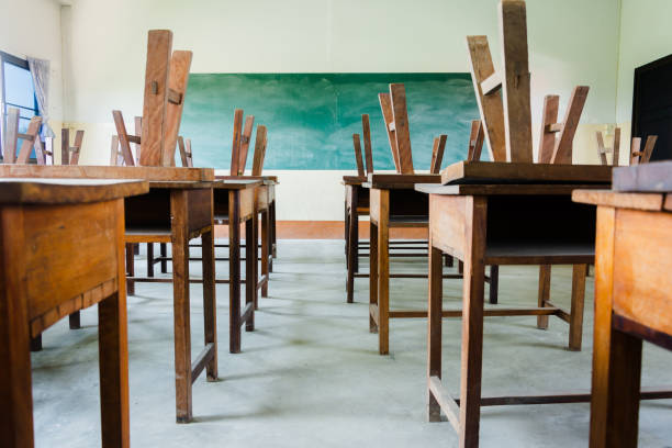 istock chair and table in class room with black board background, no student, school closed concept 1134900323