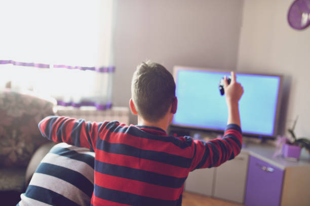 istock Two Boys Playing Games on TV 1134902286