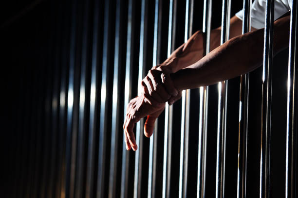 close up of hand in jail background. - cela imagens e fotografias de stock