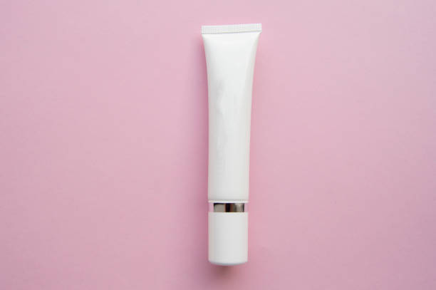 istock White plastic tube with space for text on pink background, minimalism, flat lay 1134903998