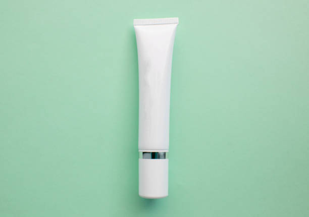istock White plastic cream tube with space for text on a light green background, minimalism, flat lay 1134904018