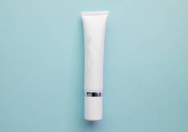 istock White plastic cream tube with space for text on light blue background, minimalism, flat lay 1134904031