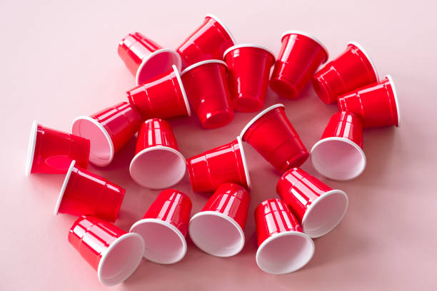 istock Red plastic party cups on pink background 1134907340