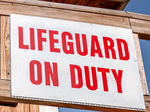 Lifeguard on duty sign at beach