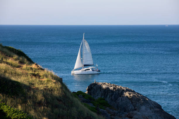 A sunny, breezy day is perfect for a catamaran sail in Kailua Bay, Hawaii.