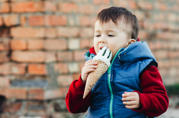 istock Cute Little Boy Eating an Ice Cream Cone 1134909074