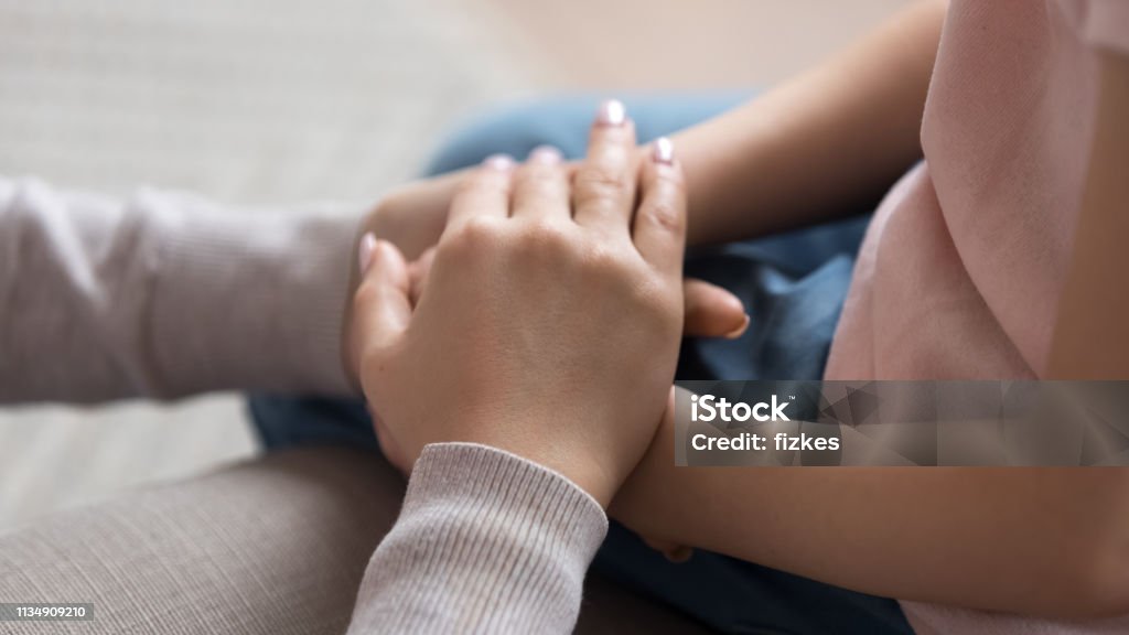 Mom giving support trust to little daughter holding hands, closeup Mom giving support trust to little daughter holding hands help child keep safe, adult parent mother and kid love, children charity adoption protection, foster care, family kindness, close up view Child Stock Photo