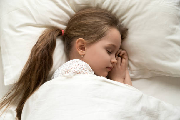 istock Cute calm little girl sleeping lying asleep in comfortable bed 1134909742