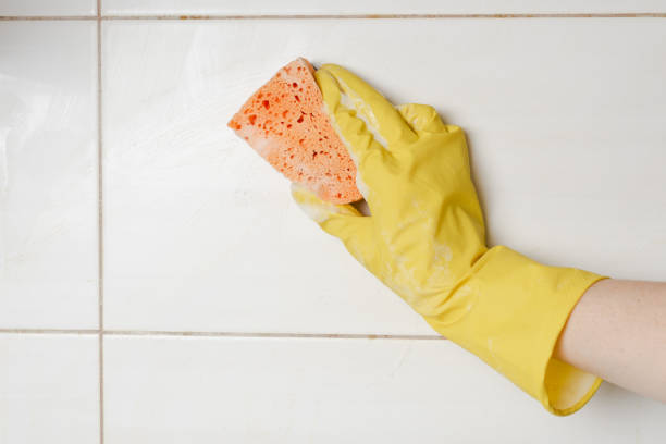 istock Close-up woman cleaning tiled surface in kitchen. 1134910500
