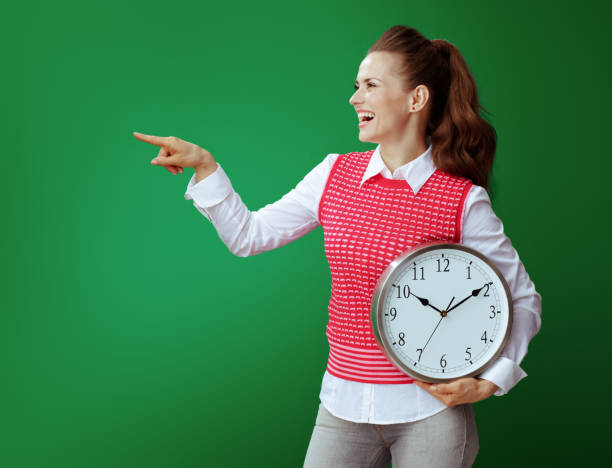istock student woman with white round clock pointing at something 1134911184