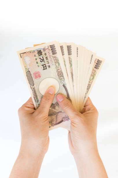 istock Hand hold a Japanese currency, isolated on white background 1134914447
