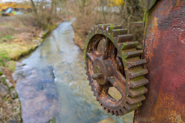 Old rusty gear wheel at a river dam for electrical energy