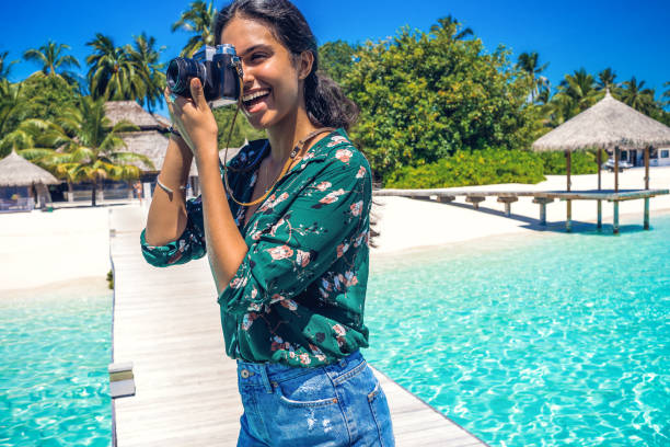 young woman enjoying her vacation and photographing woman enjoying her dream vacation Intercontinental Maldives  stock pictures, royalty-free photos & images