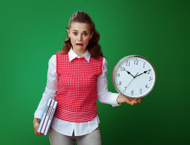 istock shocked fit learner woman with textbooks and white round clock 1134916824