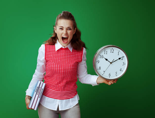 istock angry student woman with textbooks showing white round clock 1134916969