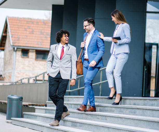 istock Three business colleagues having discussion while walking outdoors 1134916970