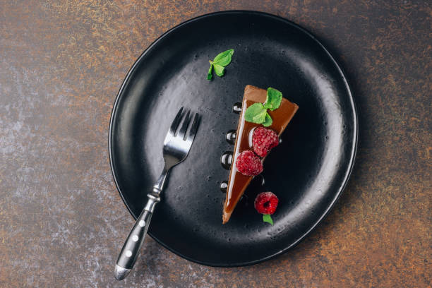 istock chocolate or coffee cheesecake with glaze, mint and raspberry 1134919214