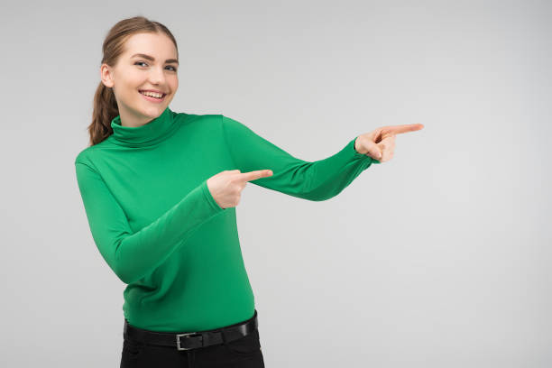 istock Cheerful young girl standing happily points out 1134926566
