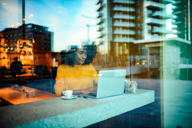 istock Smiling woman using laptop at the bar. 1134926685
