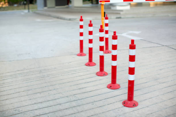 istock traffic cone, with white and Red stripes on gray concrete road 1134926820
