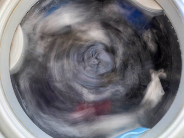 istock Top loading washing machine washes laundry. Internal view of a washing machine drum during wash. Top view. 1134927162