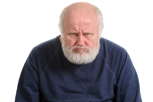 grumpy oldfart or dissatisfied and displeased old bald man isolated portrait isolated on white