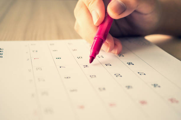 istock Hand with pen writing on calendar page closeup 1134928712