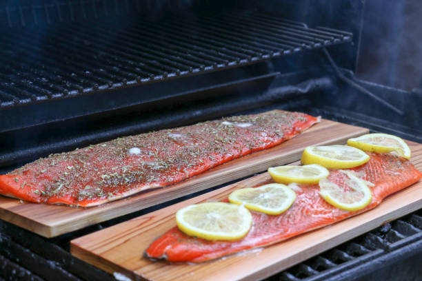 grilled salmon with lemon and dill; and a dry rub, cooked on a cedar plank - lemon fruit portion citrus fruit imagens e fotografias de stock