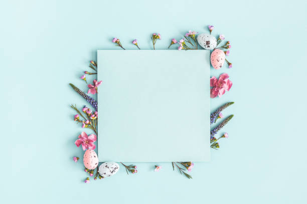 Easter composition. Easter eggs, flowers, paper blank on pastel blue background. Flat lay, top view, copy space Easter composition. Easter eggs, flowers, paper blank on pastel blue background. Flat lay, top view, copy space april photos stock pictures, royalty-free photos & images