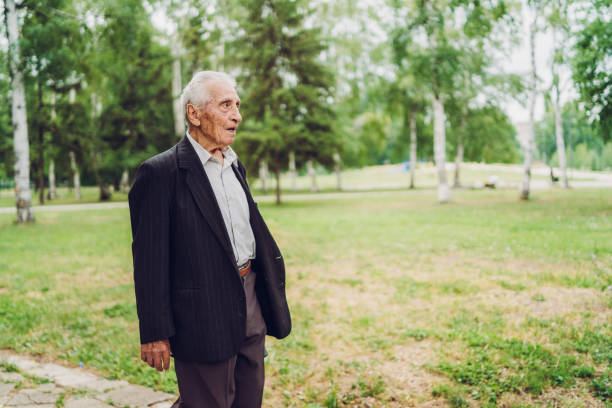 istock Senior man walking in a park 1134930184