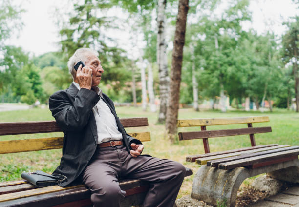 istock Senior man using phone in a park 1134930339