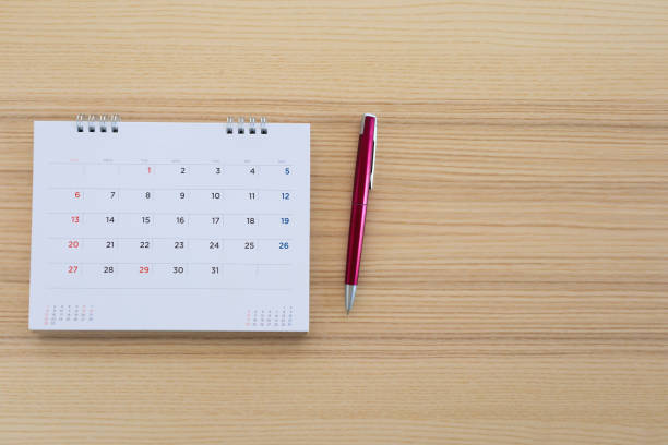 istock calendar page with pen on wood table background 1134930420