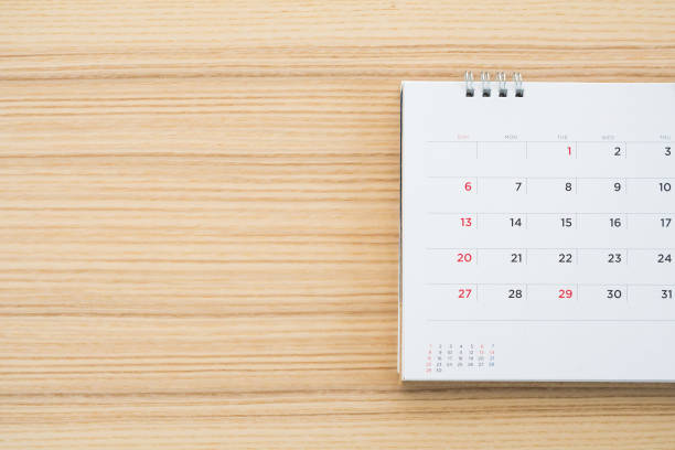 istock calendar page on wood table background 1134930423