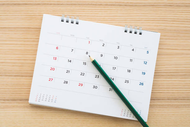 istock calendar page with pencil on wood table background 1134930425