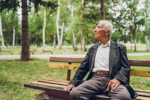 istock Senior man sitting on a park bench 1134930437