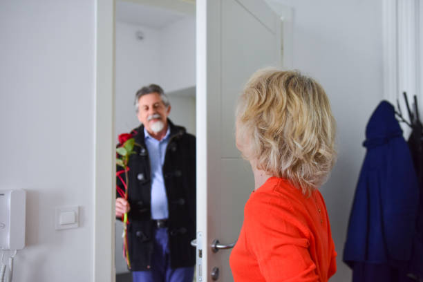 istock Senior man surprising his wife with a rose 1134930520