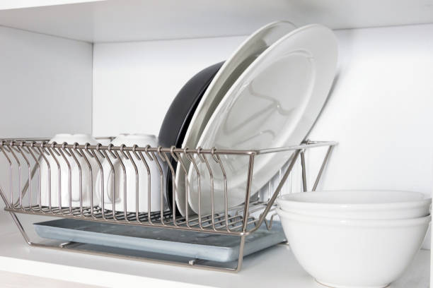 istock Kitchen cupboard with a lattice for dishes, with a white and black plate, cups, and a drip tray 1134931083