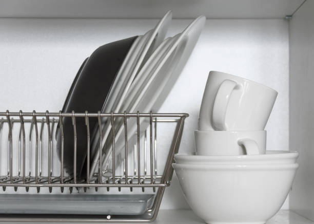 istock Kitchen cupboard with a lattice for dishes, with a white and black plate, cups, and a drip tray 1134931143