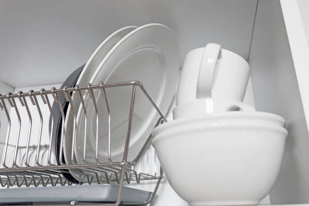istock Kitchen cupboard with a lattice for dishes, with a white and black plate, cups, and a drip tray 1134931246