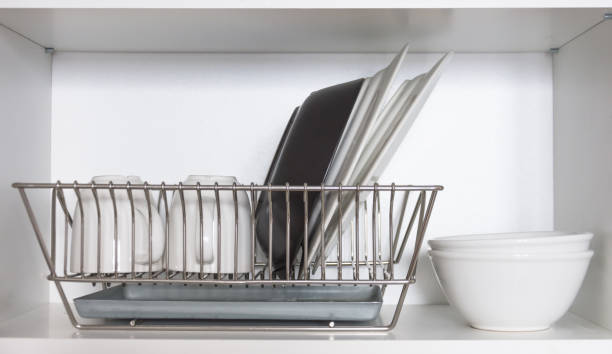 istock Kitchen cupboard with a lattice for dishes, with a white and black plate, cups, and a drip tray 1134931281