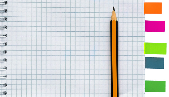 Blank notebook with pencil and stickies isolated on white background