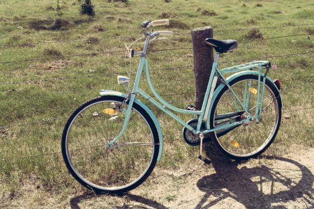 A old bicycle leaning on a fence at the german baltic sea coast.