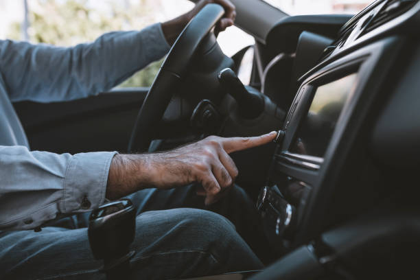 istock Man of style and status. Handsome young man in full suit smiling while driving a car 1134932771