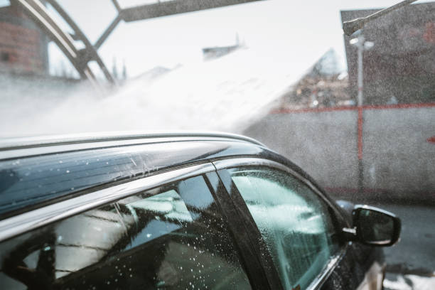 istock Man washing his car with high-pressure washing 1134933595