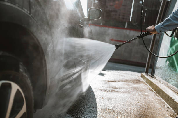istock Man washing his car with high-pressure washing 1134933780
