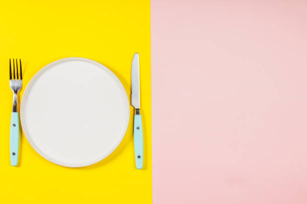 istock White plate on two color background, flat lay, top view 1134934382