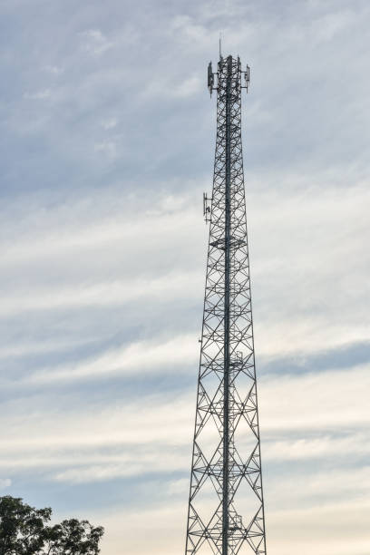Telecommunication, wireless communication tower with evening sky background.Transmitter station tower against beautiful blue sky and clouds.