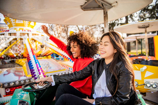 istock Two friends riding amusement park ride 1134934659