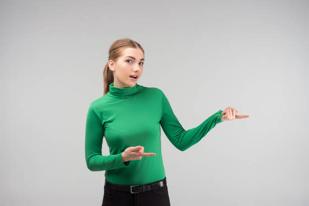 istock Young girl standing in wonder and points out 1134935224