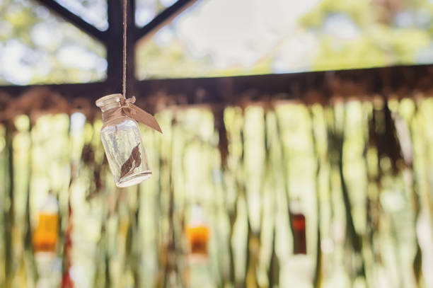 Small bottle with a leaf hanging on a rope. Herbal medicine. Aromatherapy. Medicinal plants. Spa treatment